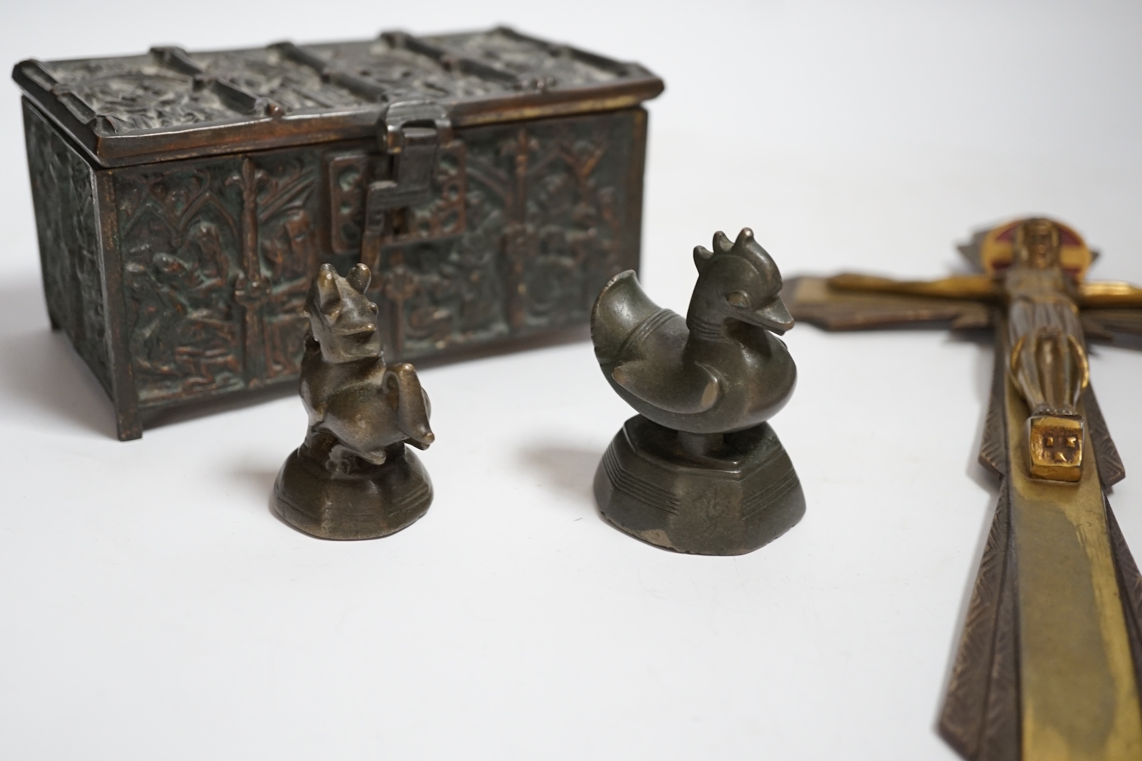 A bronze gothic casket, two Burmese bronze weights and a cast brass crucifix, 31.5cm